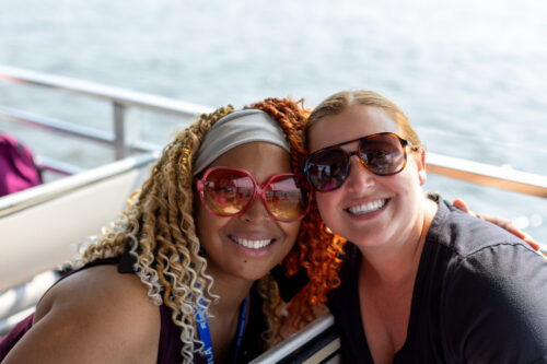 Two women smile at the camera.